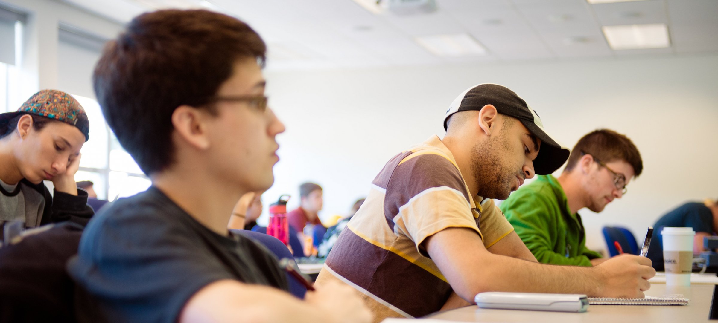 Student taking notes in Mathematics course