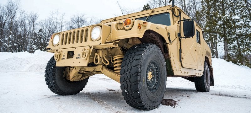 The hybrid electric High-Mobility Multipurpose Wheeled Vehicle parked in the snow.