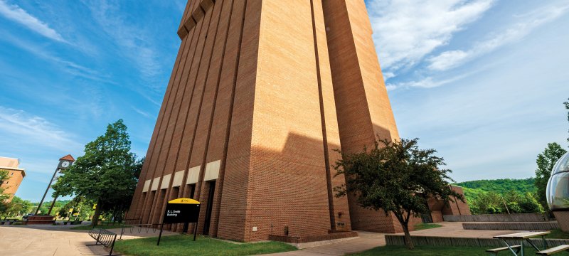 Exterior of the R. L. Smith Building with the clock tower in the background to the left.