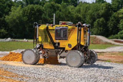 PRIMROSE excavator outside in gravel and dirt.