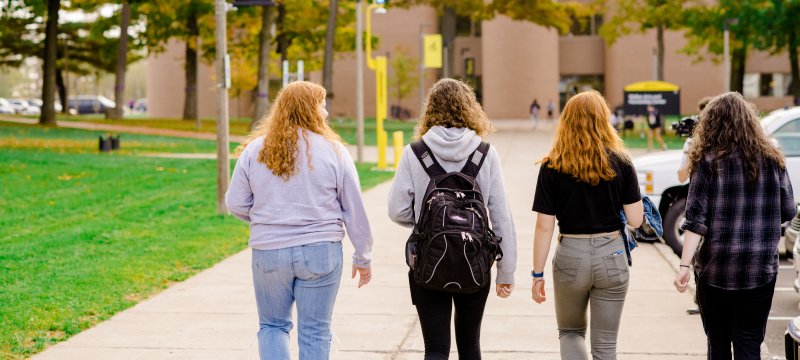 Students walk across Michigan Tech campus together.