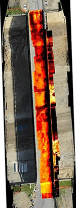 Aerial view of an overpass with red thermal imaging coloring.