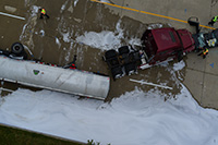 Semi truck with trailer tipped over.