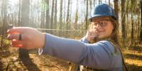 Veronica Blissick uses an angle gauge to measure trees along the Tech Trails.