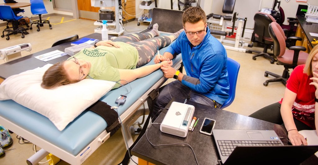 Ian Greenlund uses applanation tonometry to take a resting blood pressure measurement. Applanation tonometry reading for standing desk study