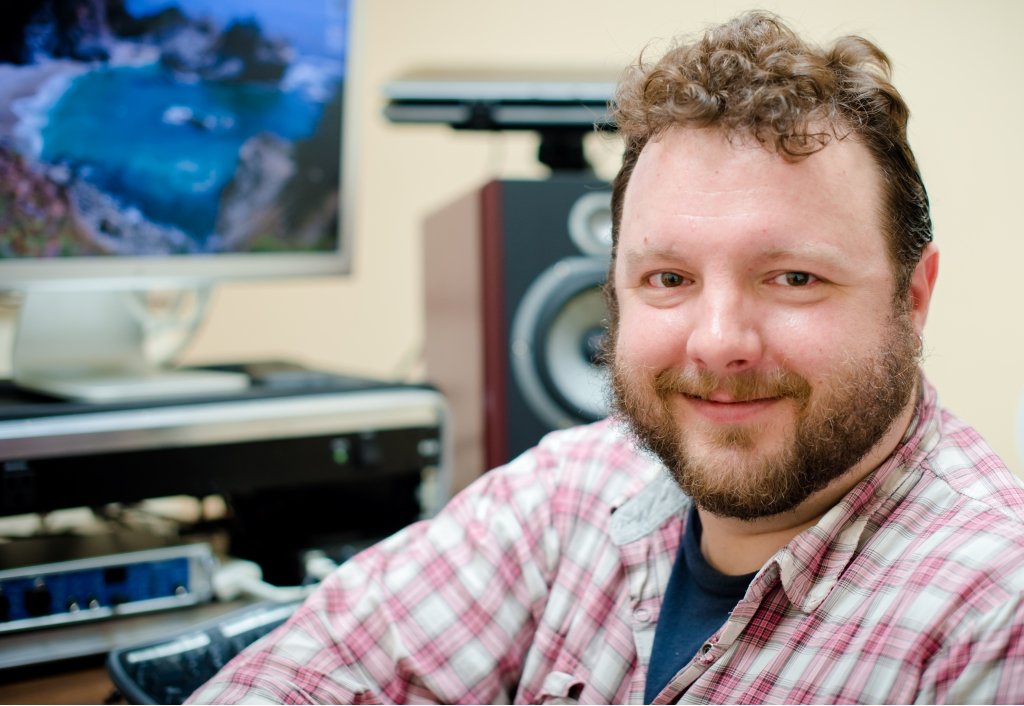 Josh Loar of Visual and Performing Arts is creating community. Josh Loar - a white man with a beard looking into the camera.