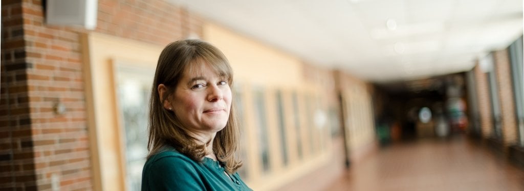 Kelly Kamm, assistant professor of kinesiology and integrative physiology shares her research Kelly Kamm of kinesiology stands in an empty hallway