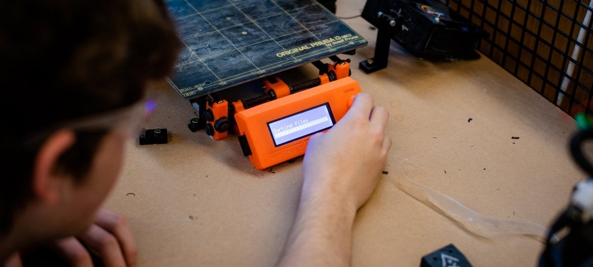 Open-source home care equipment is one of seven projects undergraduate student researchers may tackle—the projects will be prioritized by putting them to a public vote. Which do you think is most important? a student with safety glasses places his hand on test equipment with a digital readout in an open source laboratory on a college campus
