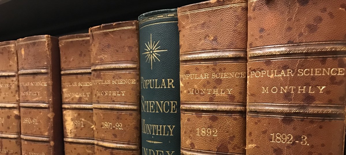 The Opie and Van Pelt Library's archive contains many bound treasures. Preserving today's publications has digital assistance. Credit: Nick Adrian A row of books sit on a shelf, the lettering is faded and reads "Popular Science Monthly".