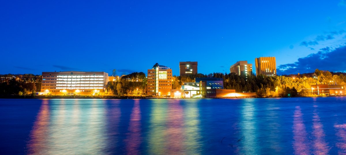 The pandemic hallways were quieter than campus at night — but the building mechanics still couldn’t listen for problems from home. Michigan Tech campus from the waterfront at night.