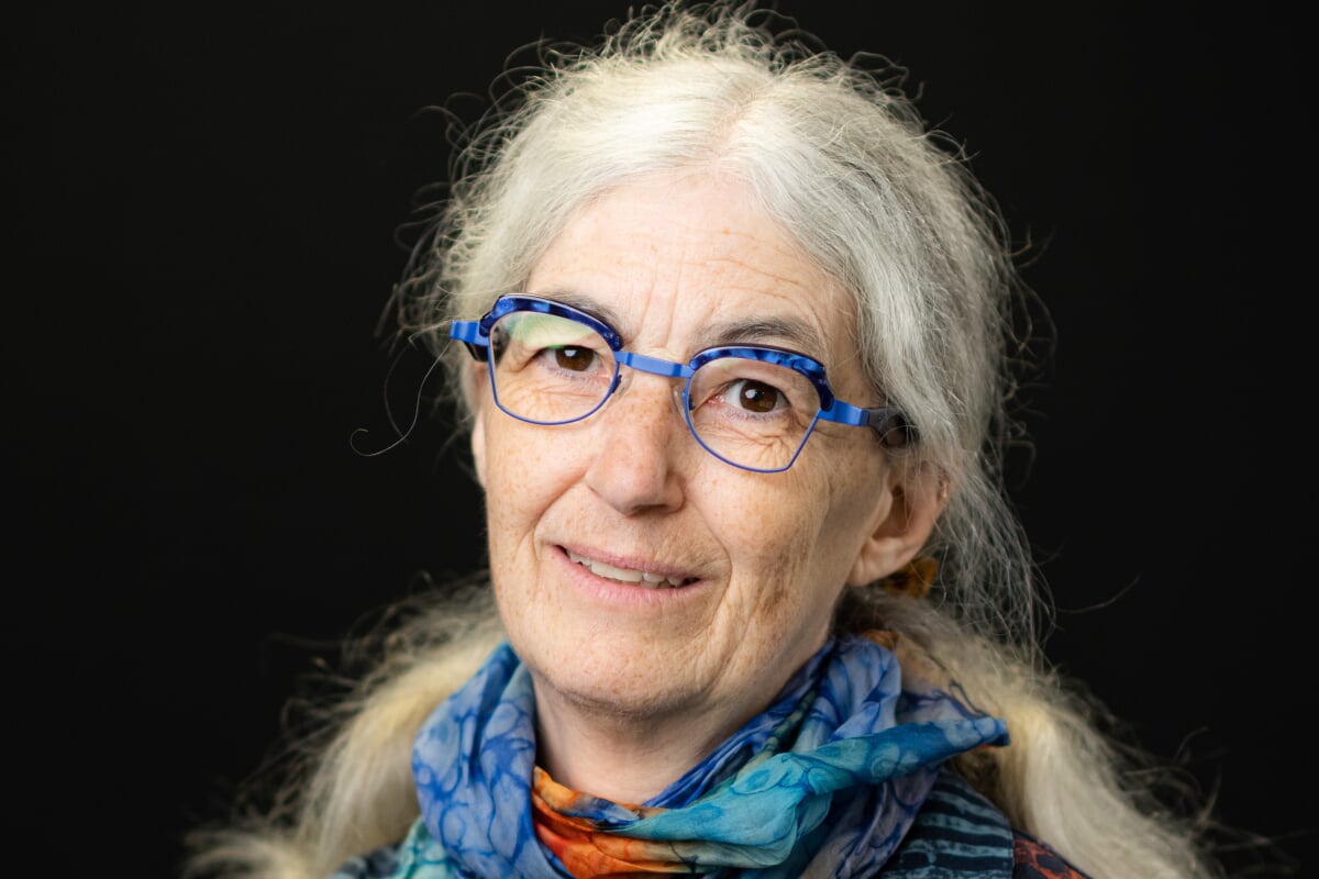 A chemist leading a Michigan Tech delegation to the UN Climate summit in a portrait wearing glasses and a colorful scarf.