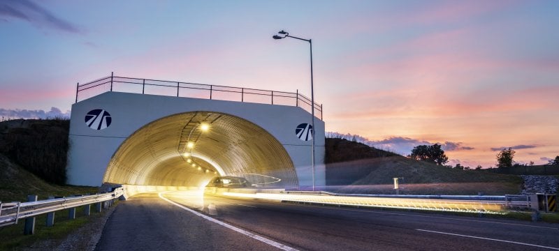 Car in motion driving through tunnel overpass at American Center for Mobility.