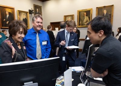 Anna Eshoo talking too Vinh Nguyen while Alex Sergeyev looks on.