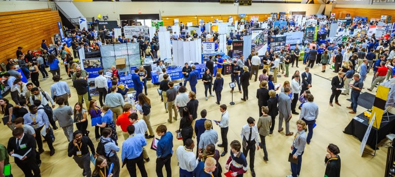 Students and recruiters gathered in a crowd on the floor of the SDC wood gym.