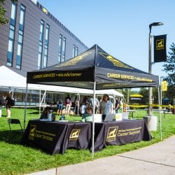 Black Career Services tent on the grass in the Husky Plaza.