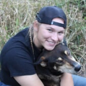 Brynn Santi hugging one of the mushing club dog.