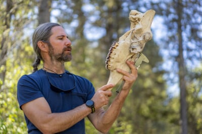 John Vucetich holding a moose skull.