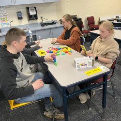 trio students play game in classroom