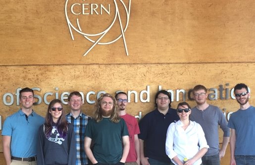 Physics in a group image at CERN sign