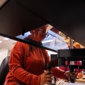 Researcher sitting behind a hand-eye coordination device.