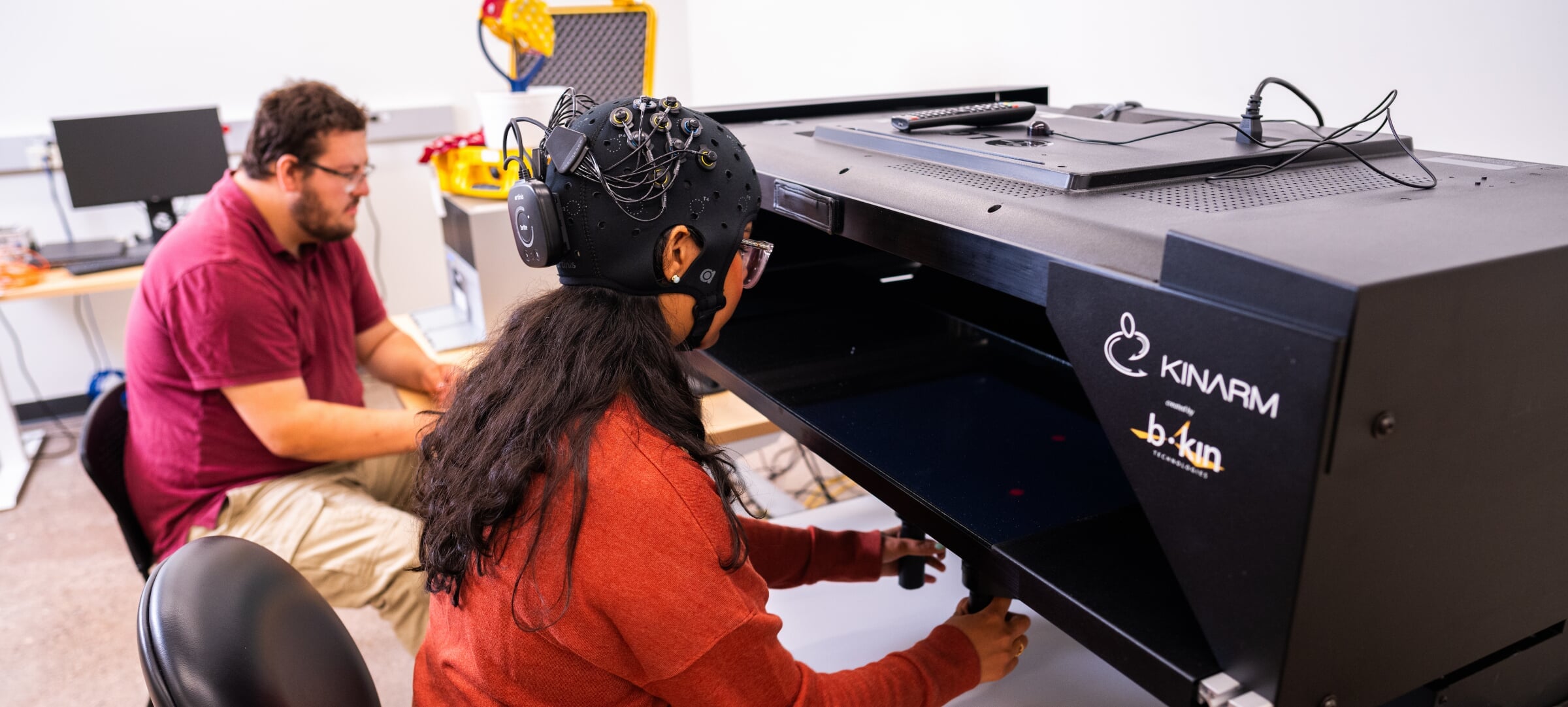 Graduate student researchers in Human Factors lab using hand-eye coordination equipment.