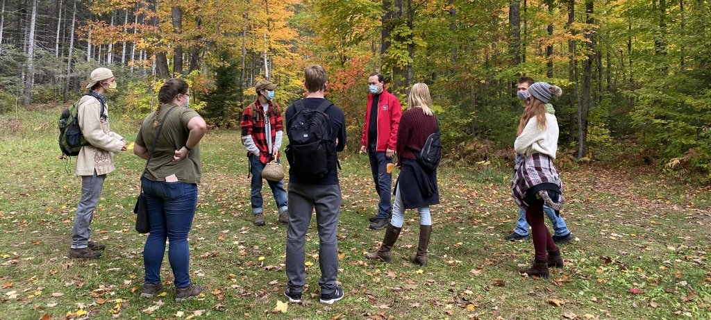 students standing in the woods