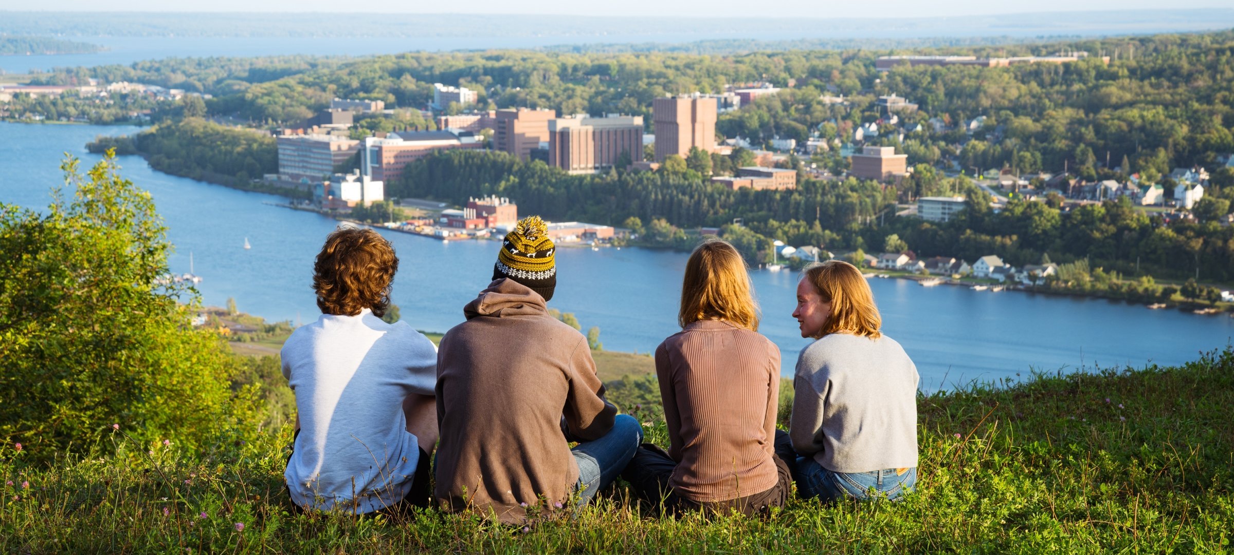 Students sitting on Mont Ripley looking at campus