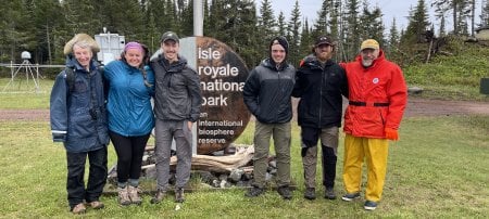 Jack Schafer, second from right, found his research path and learned life-changing lessons in leadership during fieldwork in Isle Royale National Park. This photo, snapped by an Isle Royale Park employee at the docks, includes longtime wolf-moose project contributor Candy Peterson, 2023 wolf-moose project interns Suzie Ronk, Louis Good, Michigan Tech interns Wesley McGee and Schafer, and wolf-moose project co-leader Rolf Peterson. (Image courtesy Suzie Ronk and Jack Schafer)