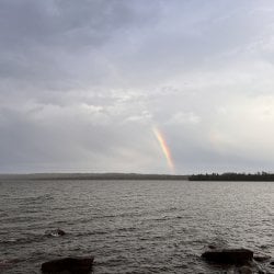 Looking over the water at a ranbow on the far shore.