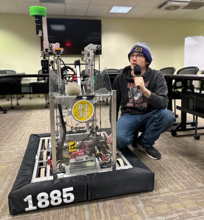 Copper Country Robotics president Kyle Hildebrand poses with CCR's complete prototype, Blizzard T. Robot.