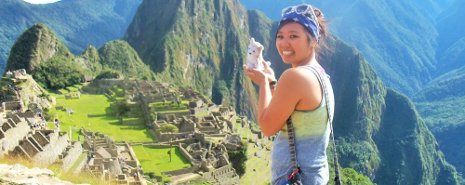 Study abroad student with a stuffy husky, overlooking some ancient ruins.