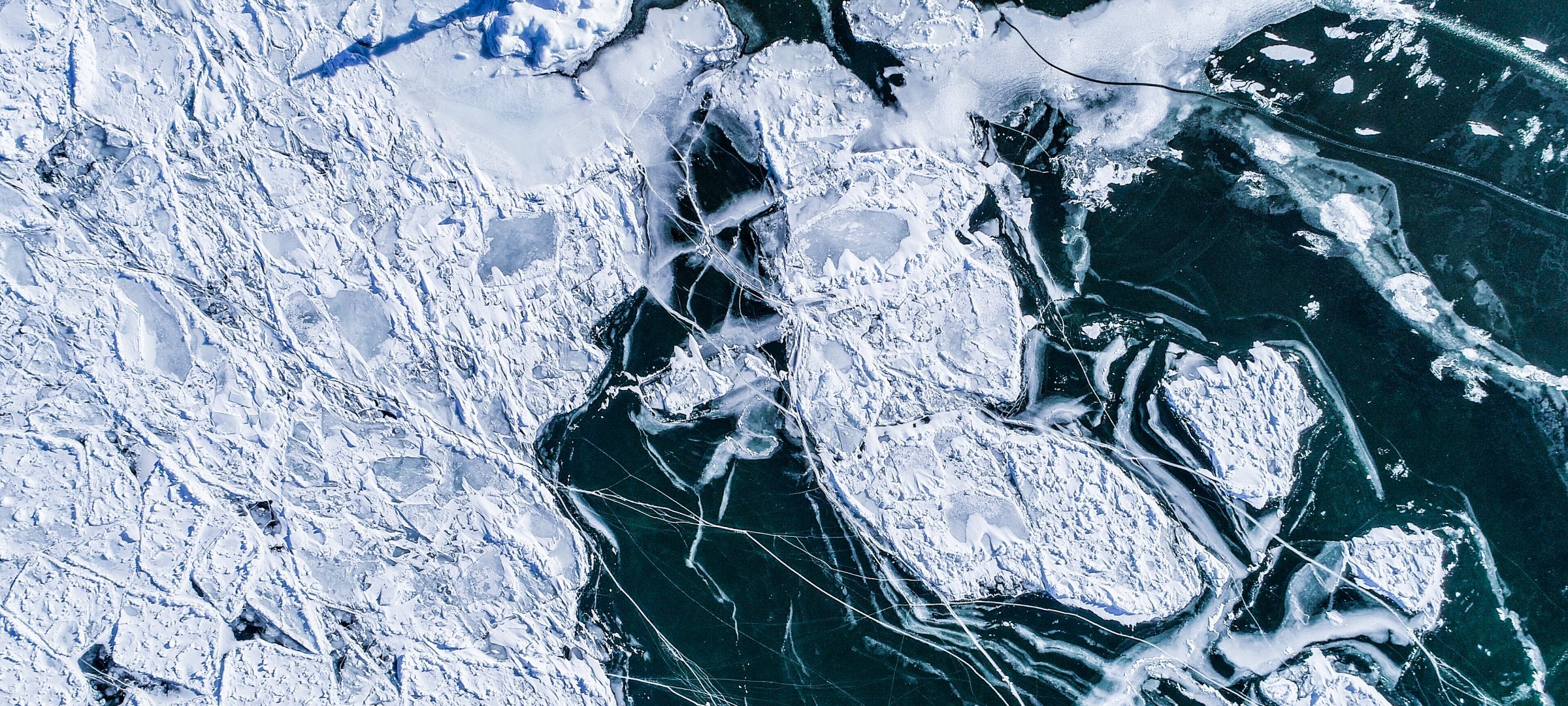 Aerial view of winter ice cover over lake