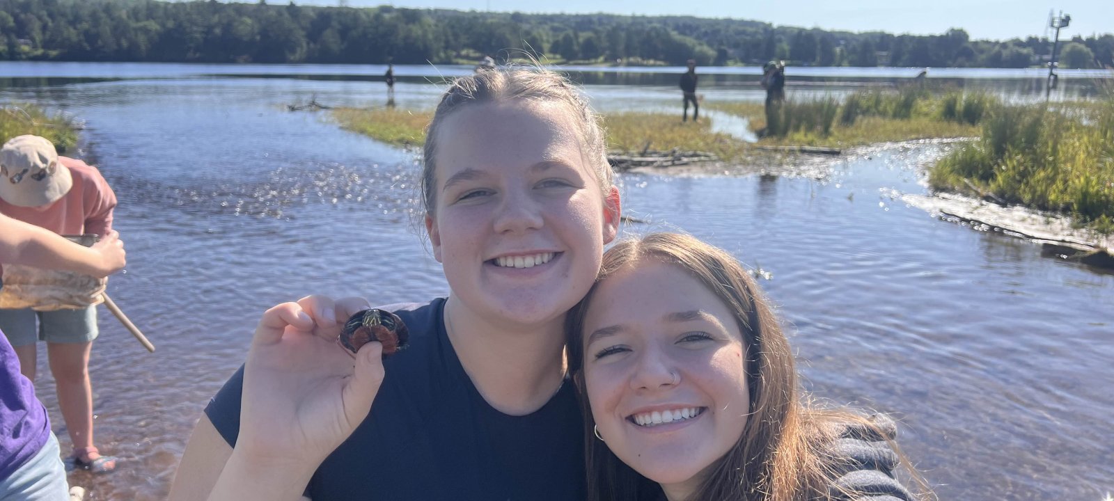 wildlife ecology students share a turtle