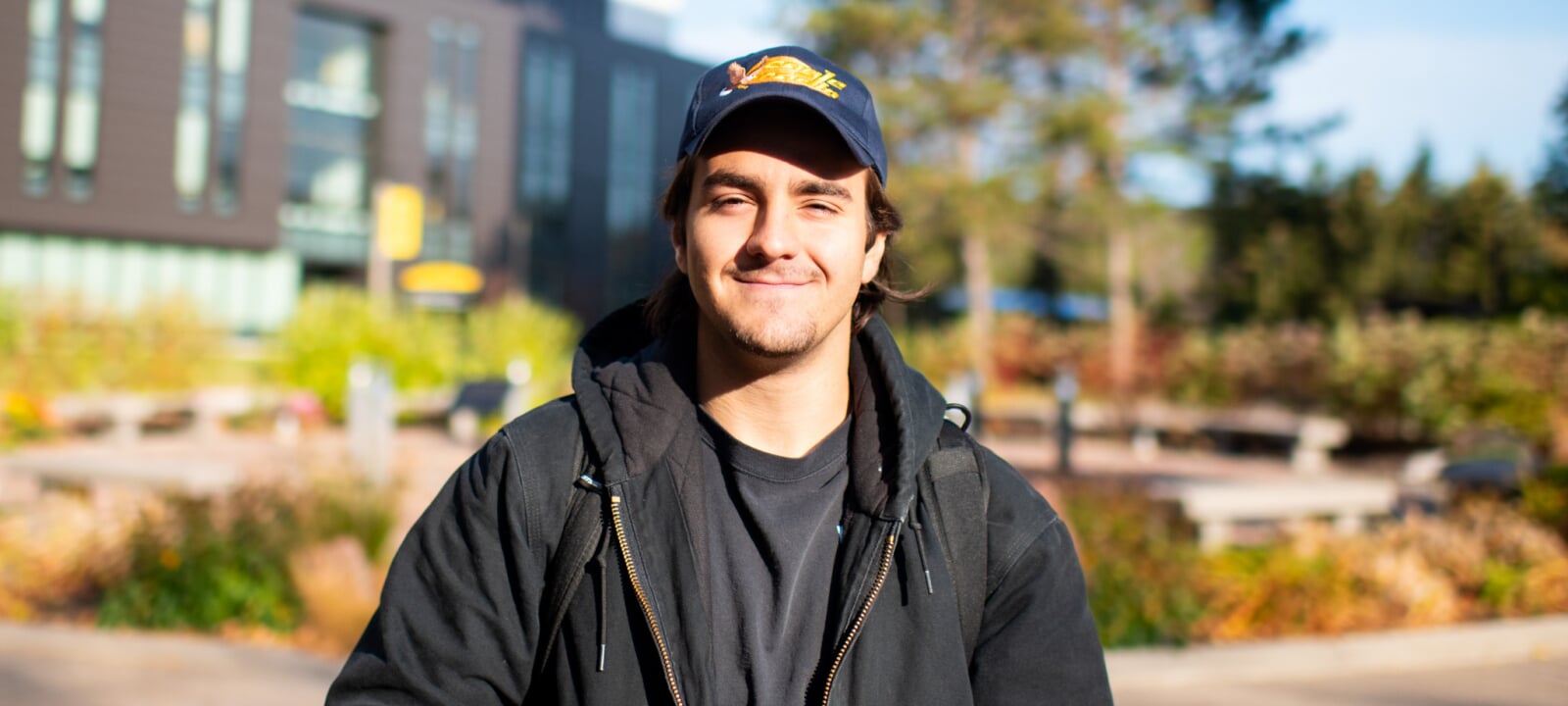 Pietrino Censoplano smiling in front of the Husky statue
