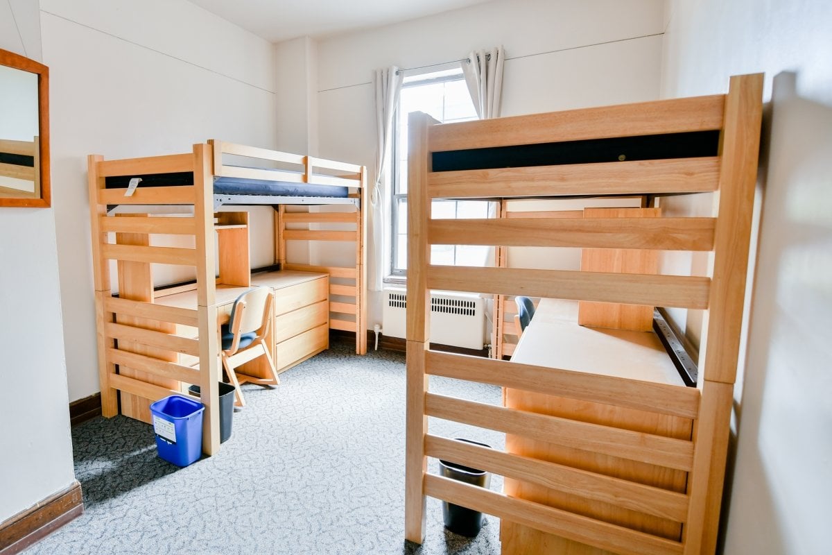 Two loft beds in a residence hall room.