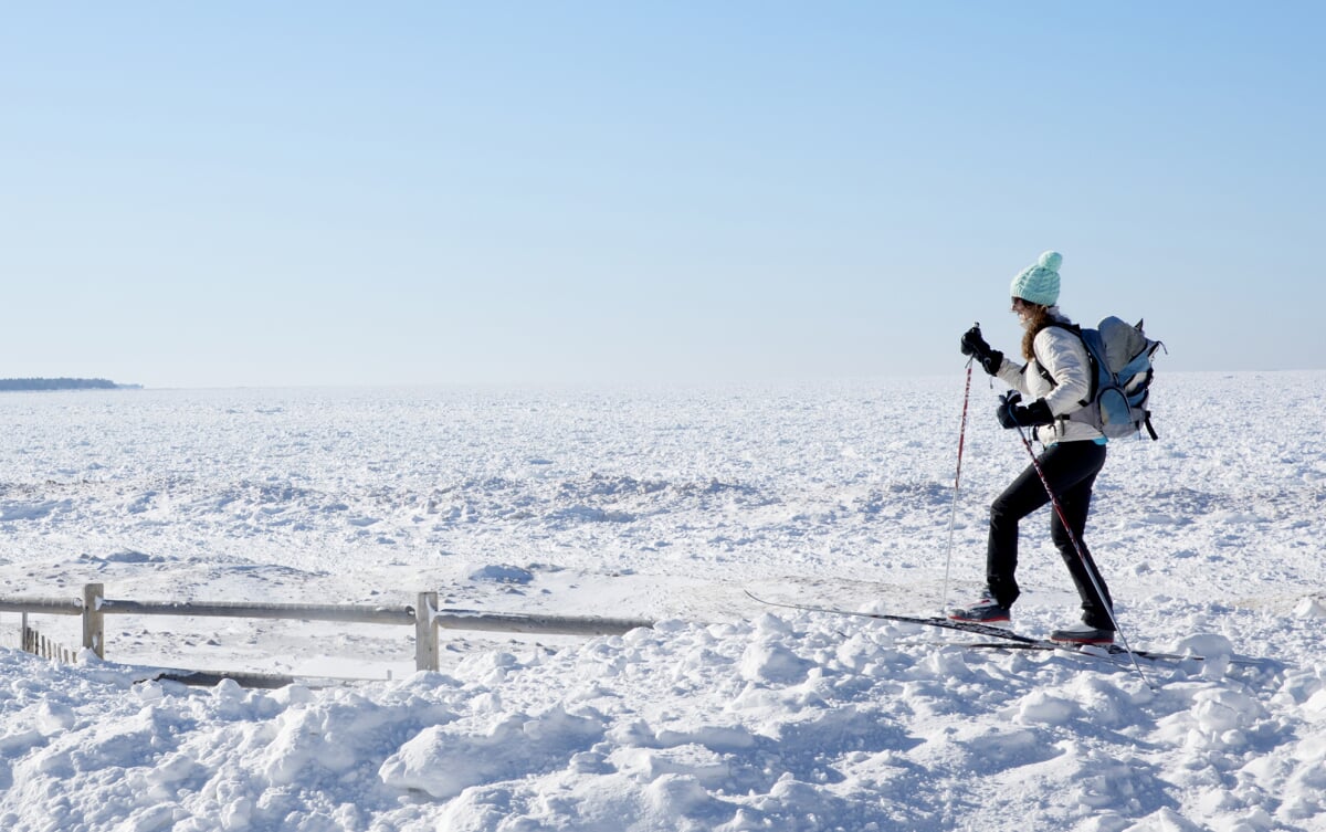Person snowshoeing through a wide open space.