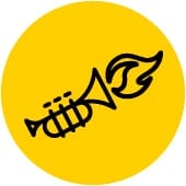 Gold background with black icon of the Essential Ed icon for Create, a flaming trumpet.