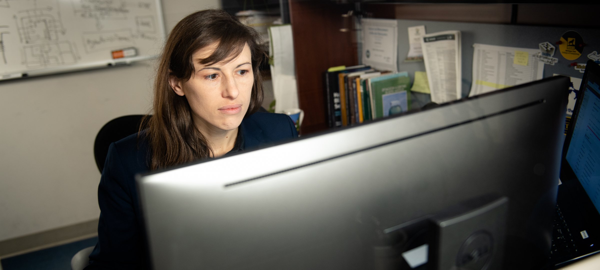 Staff addressing content debt at a computer seated at a desk.