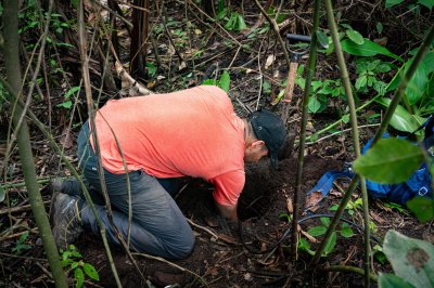 Gustavo digs a borehole to install a seismic sensor.