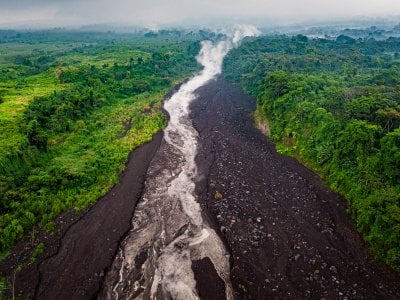 A lahar, a mixture of volcanic debris and water, forms on the flanks of Volcan de Fuego.