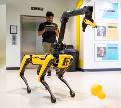 A student controls Balto in the hallway of Rekhi Hall.