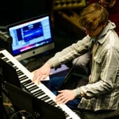 Student playing on a keyboard.