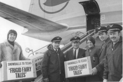 Four pilots, a stewardess and a man in a 1970s fur jacket hold boxes that say &quot;Snowballs&quot; to Texas Frigid Fairy Tales in front of a Republic Airlines plane with a blue goose logo on its wing.